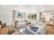 Bright living room with hardwood floors, large windows, and sliding doors to the outdoor patio at 5872 Taft St, Arvada, CO 80004