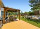 Outdoor patio area with a gazebo and landscaped yard featuring rocks and lush greenery at 5130 Morning Glory Pl, Highlands Ranch, CO 80130