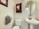 Charming powder room featuring a pedestal sink and vintage-style fixtures at 5130 Morning Glory Pl, Highlands Ranch, CO 80130