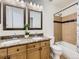 Bathroom featuring dual sinks, granite counters, and a shower-tub combination at 5130 Morning Glory Pl, Highlands Ranch, CO 80130
