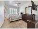 Comfortable bedroom features a ceiling fan, window with shutters, and a dresser with mirror at 5130 Morning Glory Pl, Highlands Ranch, CO 80130
