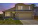 Charming two-story home with a well-manicured lawn and a welcoming front porch and two-car garage at 5130 Morning Glory Pl, Highlands Ranch, CO 80130