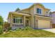 Attractive two-story home with brick accents, covered porch, and manicured landscaping at 5130 Morning Glory Pl, Highlands Ranch, CO 80130