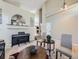 Elegant living room with a piano, arched wall detail, and stylish furnishings at 5130 Morning Glory Pl, Highlands Ranch, CO 80130