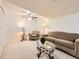 Cozy living room features comfortable seating, a ceiling fan, and soft lighting at 5130 Morning Glory Pl, Highlands Ranch, CO 80130