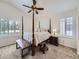 Main bedroom featuring a four-poster bed, vaulted ceiling, and shuttered windows at 5130 Morning Glory Pl, Highlands Ranch, CO 80130
