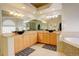 Luxury bathroom featuring a double sink vanity, granite countertop, and soaking tub at 6328 S Ouray Way, Aurora, CO 80016