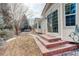 Brick steps lead to the patio and home entrance, surrounded by well-manicured landscaping at 6328 S Ouray Way, Aurora, CO 80016