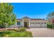 Stunning single-story home with a three-car garage, manicured lawn, and brick-paved driveway at 6328 S Ouray Way, Aurora, CO 80016