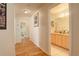 Bright hallway leading to a bathroom with granite counters at 6328 S Ouray Way, Aurora, CO 80016