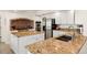 Spacious kitchen featuring a large island, granite countertops, stainless steel appliances, and tiled flooring at 6328 S Ouray Way, Aurora, CO 80016