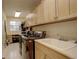 A well-equipped laundry room boasts ample cabinet storage, modern washer and dryer, and a utility sink at 6328 S Ouray Way, Aurora, CO 80016