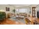 Cozy living room featuring wood floors, neutral furniture, and a fireplace at 6328 S Ouray Way, Aurora, CO 80016