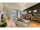 Cozy living room with hardwood floors, fireplace, and access to the outdoor patio at 6328 S Ouray Way, Aurora, CO 80016