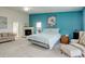 Spacious main bedroom with fireplace, seating area, and light blue accent wall at 6328 S Ouray Way, Aurora, CO 80016