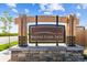 A well-designed community entrance sign, showcasing the neighborhood's name, surrounded by a well manicured landscape at 17945 E 94Th Ave, Commerce City, CO 80022