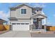 Charming two-story home showcasing a well-manicured lawn, attached two-car garage, and neutral color palette at 17945 E 94Th Ave, Commerce City, CO 80022