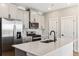 Modern kitchen featuring stainless steel appliances, a large island, sleek gray cabinets, and bright lighting at 17945 E 94Th Ave, Commerce City, CO 80022