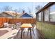 Private backyard patio with wooden deck, furniture, and an outdoor umbrella at 3521 W 40Th Ave, Denver, CO 80211