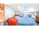 Bright attic bedroom with a large skylight and blue themed accents at 3521 W 40Th Ave, Denver, CO 80211