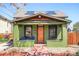 Charming home featuring a vibrant green facade, skylights, and a cozy front porch with colorful Adirondack chairs at 3521 W 40Th Ave, Denver, CO 80211