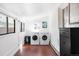 Bright laundry room with modern washer, dryer, sleek storage, and charming windows at 3521 W 40Th Ave, Denver, CO 80211