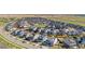 Wide aerial view of a neighborhood with Gathering homes, sidewalks, and grassy areas at 118 N Newcastle Way, Aurora, CO 80018