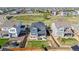 Aerial view of a blue two story home with a manicured lawn, back patio, and hot tub at 118 N Newcastle Way, Aurora, CO 80018