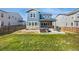 Landscaped backyard featuring green grass, a patio, a hot tub, furniture, and a partially covered area at 118 N Newcastle Way, Aurora, CO 80018