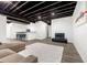 Spacious finished basement featuring an entertainment area, modern flooring, and stylish black open ceiling at 118 N Newcastle Way, Aurora, CO 80018