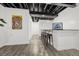 Finished basement area with modern flooring and a bar setup with bar stools at 118 N Newcastle Way, Aurora, CO 80018
