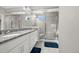 Modern bathroom featuring granite countertops, double sinks, and a glass-enclosed shower for a spa-like experience at 118 N Newcastle Way, Aurora, CO 80018