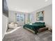 Serene bedroom with natural light, plush carpet, and comfortable seating area, providing a relaxing retreat at 118 N Newcastle Way, Aurora, CO 80018