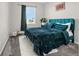 Bedroom with a teal bed and a window showcasing a view at 118 N Newcastle Way, Aurora, CO 80018