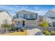 Beautiful two-story home featuring stone accents, a covered porch, and a two-car garage at 118 N Newcastle Way, Aurora, CO 80018