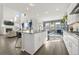 Open-concept kitchen with large island, granite countertops, modern appliances, and seamless flow to living area at 118 N Newcastle Way, Aurora, CO 80018