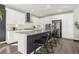 Gourmet kitchen with granite countertops, stainless steel appliances, and a breakfast bar at 118 N Newcastle Way, Aurora, CO 80018