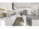 Modern kitchen boasts stainless steel appliances, granite countertops, and white cabinetry with ample storage space at 118 N Newcastle Way, Aurora, CO 80018