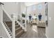 Bright living room with a soaring ceiling, large windows, a fireplace, and modern finishes at 118 N Newcastle Way, Aurora, CO 80018