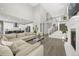 Open-concept living area featuring a two-story ceiling, a fireplace, hardwood floors, and a modern kitchen at 118 N Newcastle Way, Aurora, CO 80018