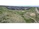 Scenic aerial shot of a Gathering community set amongst grassy open space and walking trails at 22674 E Henderson Dr, Aurora, CO 80016