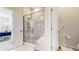Modern bathroom with a glass-enclosed shower featuring marble-like tiling at 22674 E Henderson Dr, Aurora, CO 80016