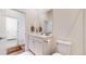 Bathroom features a white marble countertop, white cabinets, and views into the hall at 22674 E Henderson Dr, Aurora, CO 80016