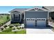 Charming home featuring a two-car garage, covered porch, and attractive landscaping at 22674 E Henderson Dr, Aurora, CO 80016