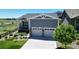 Charming home featuring a two-car garage, covered porch, and attractive landscaping at 22674 E Henderson Dr, Aurora, CO 80016