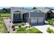 Charming single-Gathering home featuring a well-manicured lawn and inviting front porch, and a two car garage at 22674 E Henderson Dr, Aurora, CO 80016