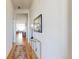 Long hallway with hardwood floors and a view of the living room at the end at 22674 E Henderson Dr, Aurora, CO 80016