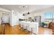 Bright kitchen featuring white cabinets, stainless steel appliances, and a quartz island with barstool seating at 22674 E Henderson Dr, Aurora, CO 80016