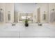 Bright bathroom with double vanity sinks, white cabinets, and granite countertops at 2434 S Williams St, Denver, CO 80210