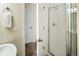 Bathroom featuring a glass door shower, a white towel and a tiled floor at 2434 S Williams St, Denver, CO 80210